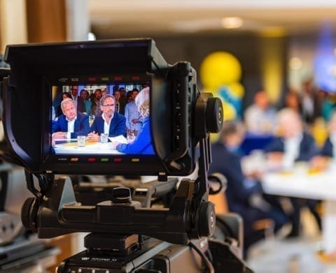 Camera focusing on the table with presenters