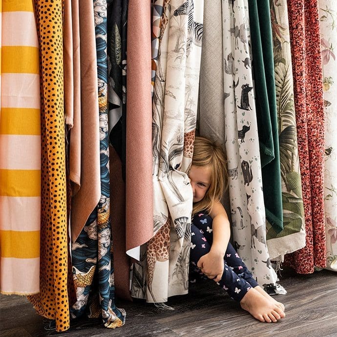 girl between curtains